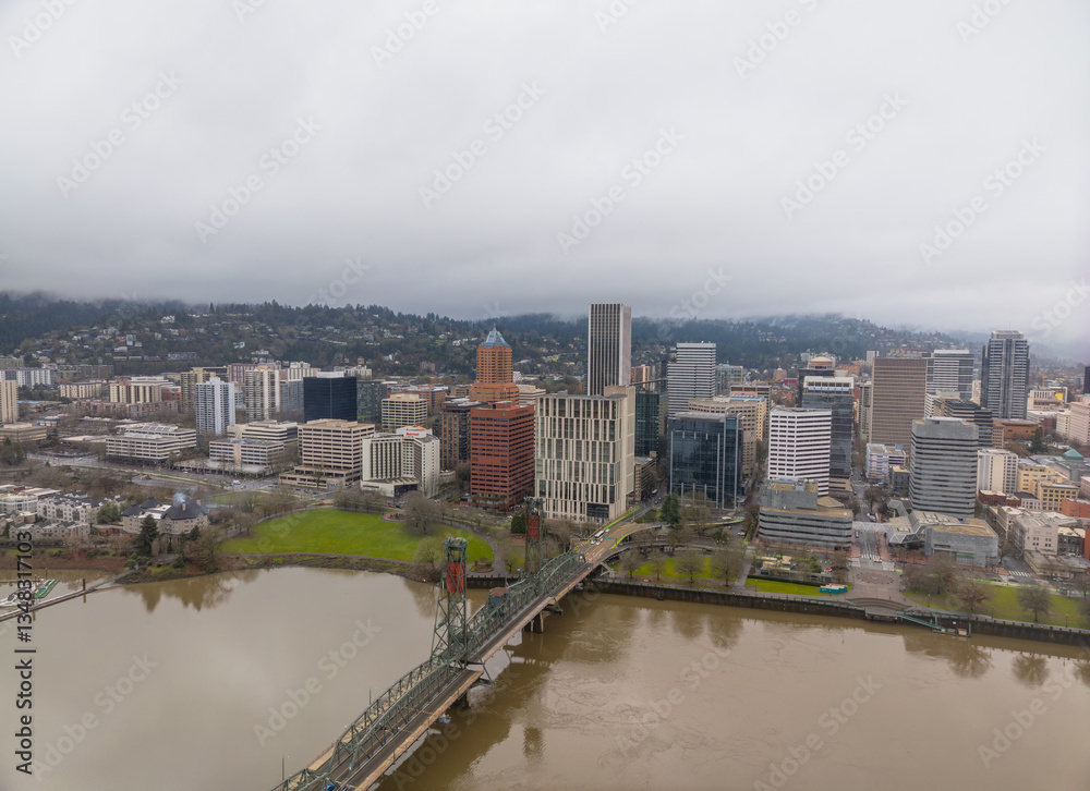 Fototapeta premium A city with a river running through it and a bridge over it