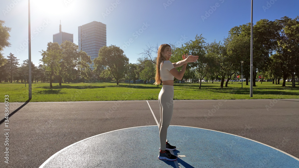 Young woman stretching after exercise and jogging in urban park
