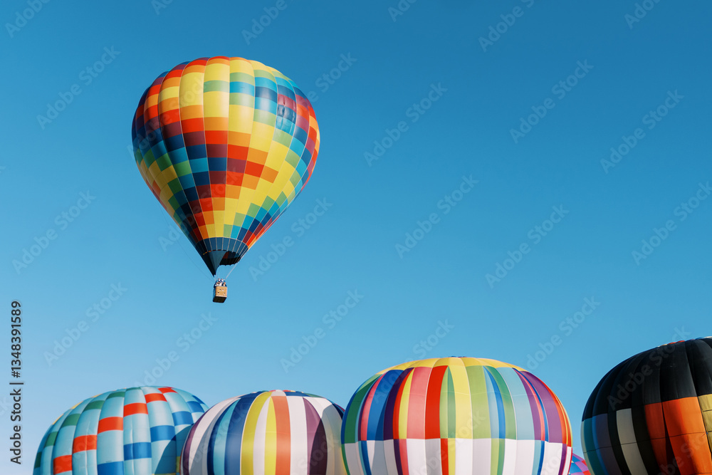 Obraz premium Colorful Hot Air Balloons in Clear Blue Sky