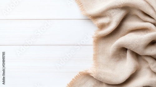 Beige fabric draped on white wooden surface