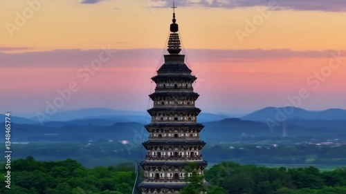 A temple stands majestically against the backdrop of a clear blue sky, its intricate architecture adorned with ornate carvings and vibrant colors.