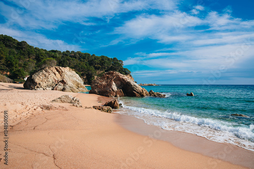 Idyllic Mediterranean beach on Costa Brava, Spain, with turquoise waters, golden sand, and scenic cliffs—perfect summer vacation destination