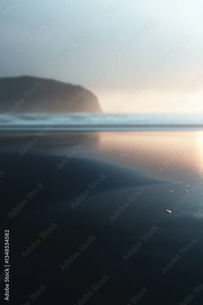 Obraz premium Serene coastal landscape with damp beach sand and gentle ripples at sunset