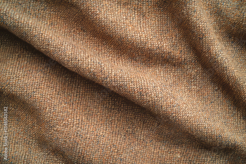 A warm, soft wool tweed fabric texture background in earthy brown tones. The coarse weave with visible flecks creates a timeless, vintage aesthetic perfect for tailored jackets, hats, and autumn decor