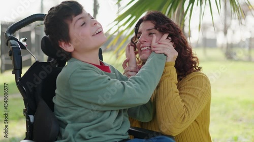 Disabled child and mother sharing a tender moment in the park photo