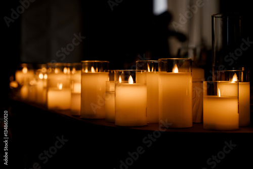 Close-up of several artificial candles, against a dark background