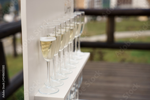 Several glasses with champagne
 alcohol stand exactly on the podium