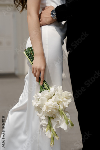 the main bride's bouquet, the groom hugs the bride around the waist