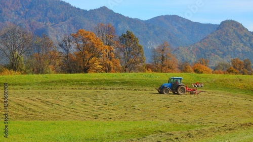 Tractor on the grass field in autumn in Zasip village in Bled, Triglav National Park, Julian Alps, Slovenia, Europe