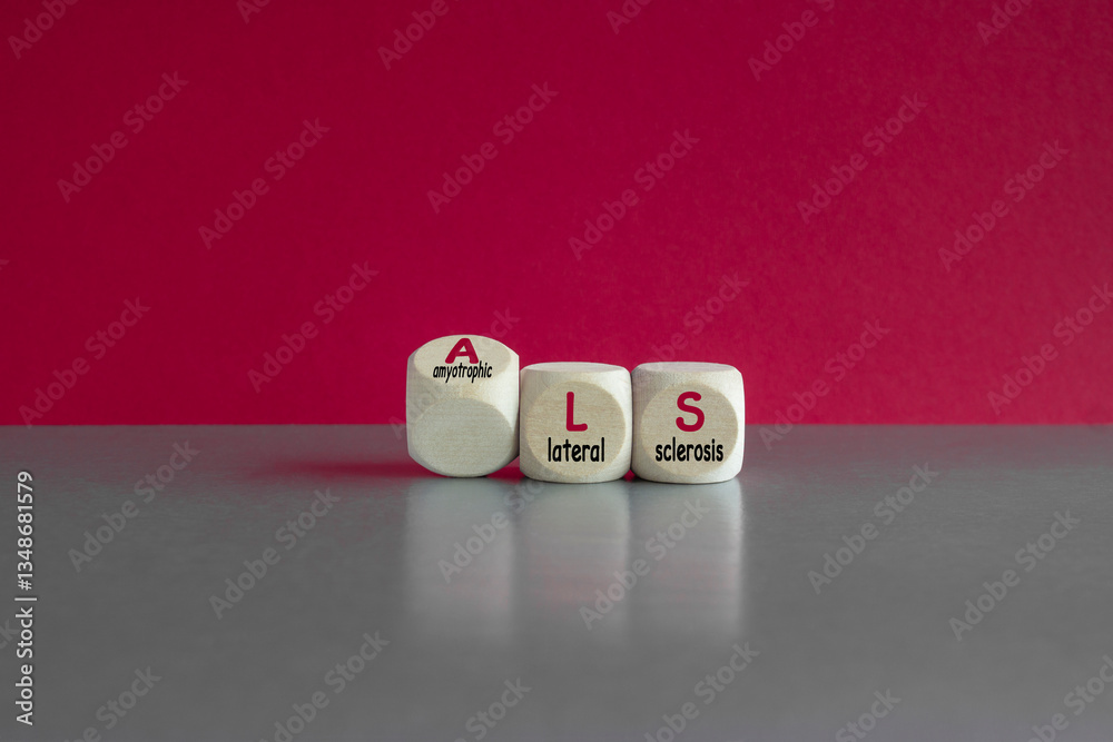 Dices form the acronym ALS (amyotrophic lateral sclerosis). Beautiful red background, gray table. Medical and amyotrophic lateral sclerosis concept.