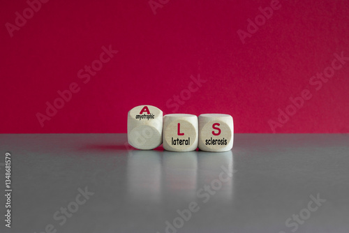 Obraz na płótnie Dices form the acronym ALS (amyotrophic lateral sclerosis). Beautiful red background, gray table. Medical and amyotrophic lateral sclerosis concept. w salonie