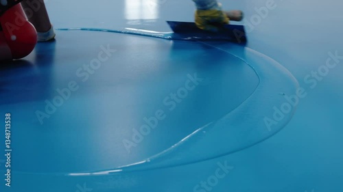 Wallpaper Mural Construction worker applying blue epoxy resin on floor Torontodigital.ca