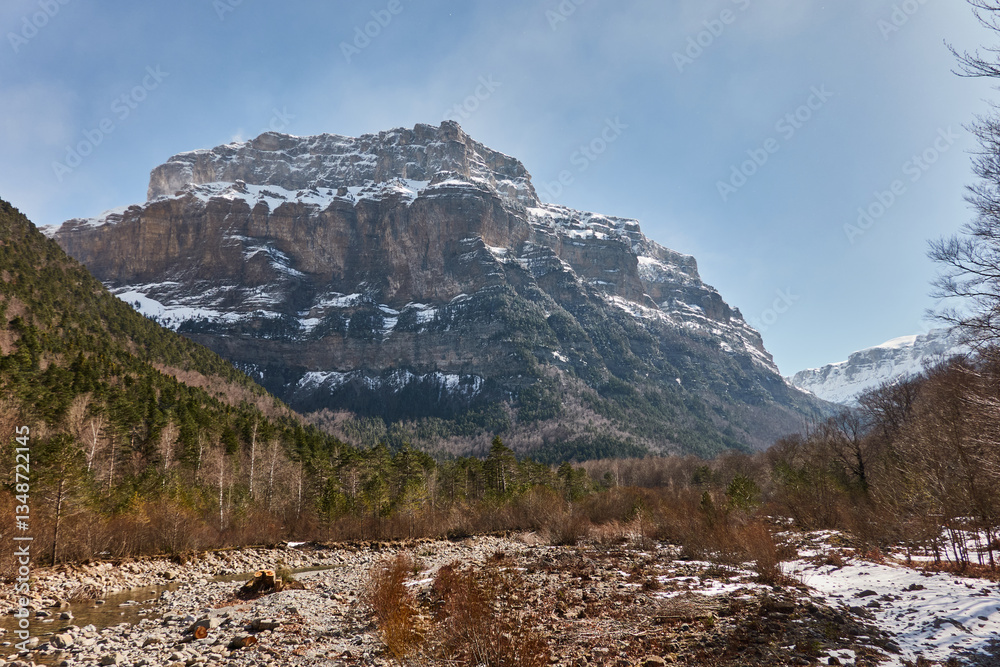 Fototapeta premium The Ordesa Valley, in the Ordesa and Monte Perdido National Park, completely covered in snow during winter. A stunning white landscape in the Pyrenees, offering breathtaking views of the untouched wil