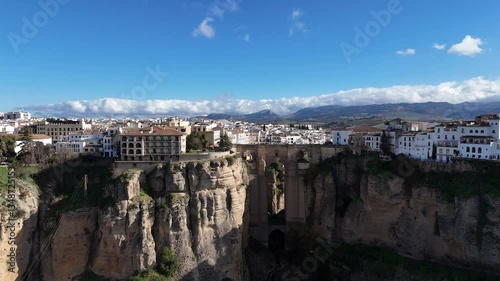 Aerial dolly out revealing Ronda white town in Malaga, Spain