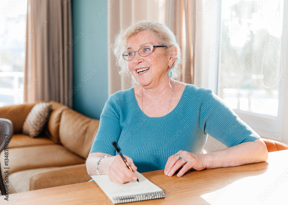 Smiling Elderly Woman Writing in a Notebook and Looking Away Smiling Elderly Woman Writing in a Notebook and Looking Away