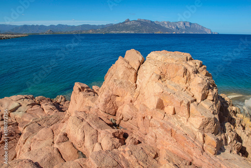 red granite rock on the edge of a the clear sea in Sardinia Italy - Rocce Ros...