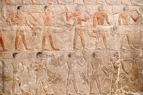 Mural from the mastaba of the Egyptian vizier Mereruka showing funerary offering procession with men carrying fowl and meet in two registers