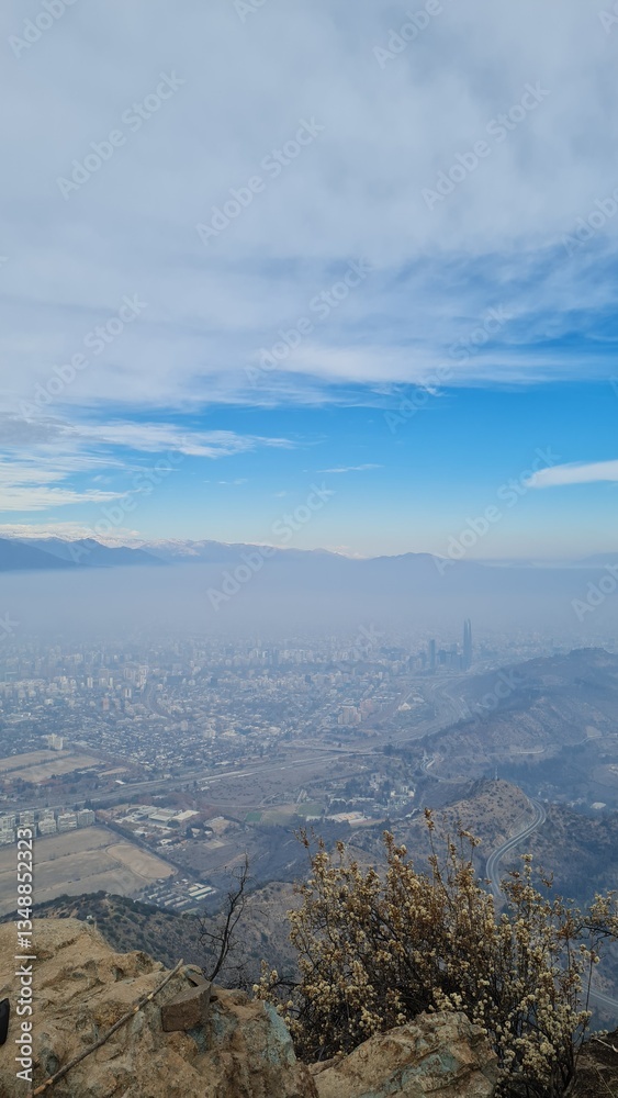 Fototapeta premium A stunning panoramic view of Santiago city with the Andes mountains in the background, captured from a hilltop. Urban landscape meets natural beauty in Chile.