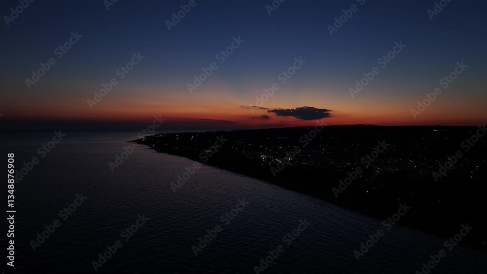 Breathtaking 4K aerial sunset over the sea, with vibrant colors painting the sky and water Breathtaking 4K aerial sunset over the sea, with vibrant colors painting the sky and water