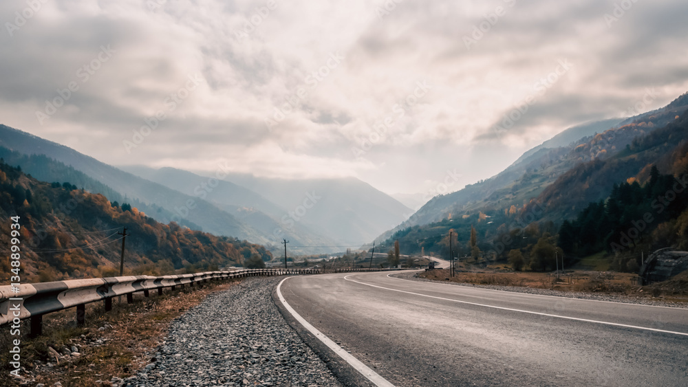 Fototapeta premium background mountain road and sky with clouds in the afternoon in Georgia
