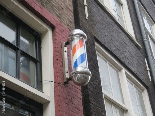 sign of a hairdreser with whirling  red, white and blue stripes