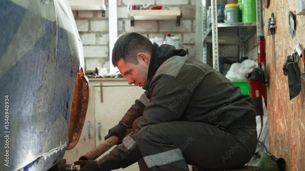 Professional mechanic replacing vehicle wheel, using specialized equipment inside modern automotive repair workshop, showcasing expert mechanical skill and precision Professional mechanic replacing vehicle wheel, using specialized equipment inside modern automotive repair workshop, showcasing expert mechanical skill and precision
