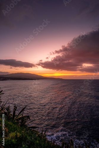 Obraz na płótnie Beautiful view of the coast of Sao Miguel, along the coast towards the Dog Face islet of Sao Miguel, Azores, Portugal during sunset or sunrise. Azores with ocean views and rock formations w salonie