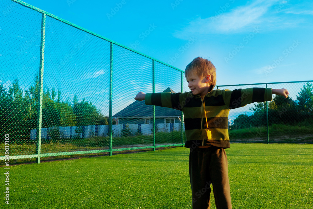 The child goes in for sports at the stadium. The boy training before playing football. High quality photo