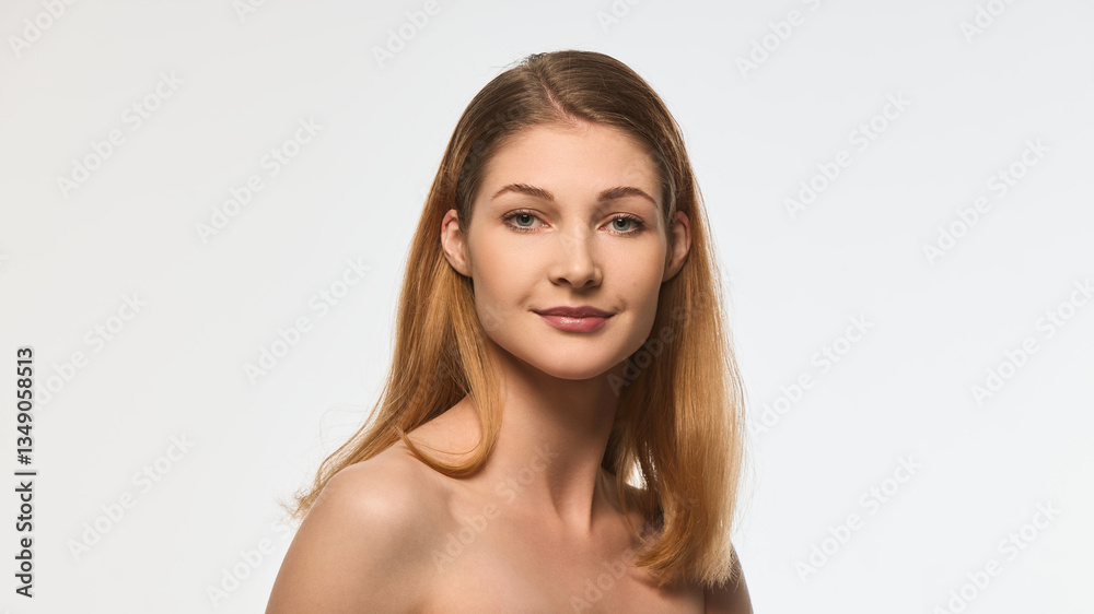 Charming woman with radiant skin and delicate smile, natural makeup, smooth hair cascading over shoulder, looking into camera. Concept of beauty, skincare, wellness, self-care, cosmetics, femininity. Charming woman with radiant skin and delicate smile, natural makeup, smooth hair cascading over shoulder, looking into camera. Concept of beauty, skincare, wellness, self-care, cosmetics, femininity.