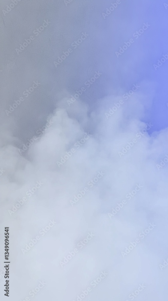 Fototapeta premium A soft blend of white and blue smoke fills the frame, creating a dreamy and ethereal atmosphere.