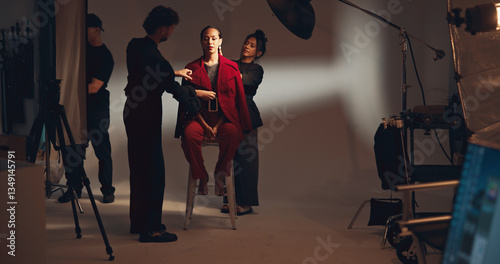 People, crew and model for photoshoot in studio of media photography, getting ready and behind the scenes. Stylist, team and prepare for film production, clothes setup and catalog of fashion industry