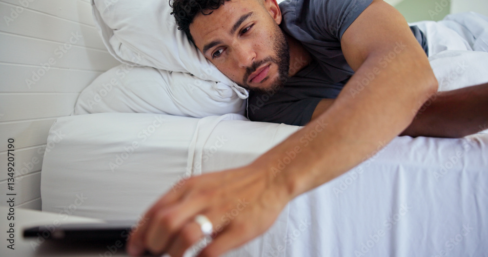Fototapeta premium Man, bed and wake up with phone alarm for morning routine, start day and sound alert in home. Sleepy, person and mobile notification in bedroom to get up, lazy weekend and awake with smartphone app