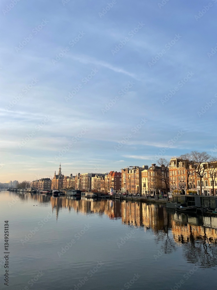 A morning walk through Amsterdam on a spring day with blue sky. The sun was coming up and the city comes slowly to life. A morning walk through Amsterdam on a spring day with blue sky. The sun was coming up and the city comes slowly to life.