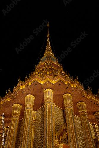 watphraphutthabat-saraburi  : The resplendent golden temple shimmers against the dark, creating an atmosphere of serene beauty, inviting exploration and contemplation. A beacon of culture. 