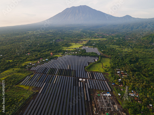 Aerial View of Solar Power Plant with Majestic Volcano in the Background, Indonesia.