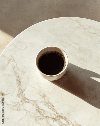 Minimalist morning: black coffee on marble surface in natural light