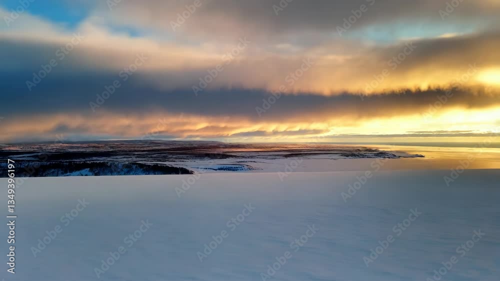 Snow-covered landscape with sunset colors and dramatic clouds Snow-covered landscape with sunset colors and dramatic clouds