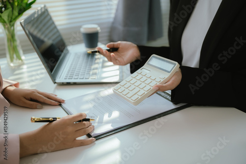 Real estate agents and new homeowners discuss mortgages and insurance coverage for safe investment and ownership.