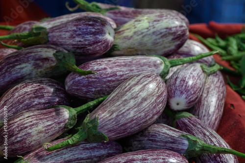 Wallpaper Mural Freshly harvested striped eggplants at a vibrant local market, showcasing their unique colors under bright natural light Torontodigital.ca