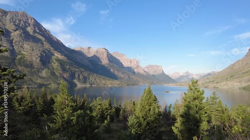 Sunrise panning of St. Mary Lake and Wild Goose Island in Glacier National Park, Montana with Fusillade, Gunsight, Dusty Star, Little Chief and Mahtotopa Mountains in the background. photo