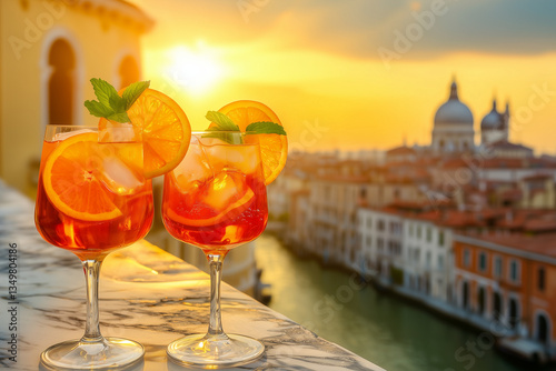 Fototapeta Naklejka Na Ścianę i Meble -  Classic Aperol Spritz with Orange Slices and Ice Overlooking Venice Sunset