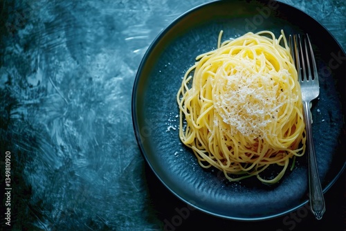 Delicious Spaghetti Topped With Cheese Served on a Dark Plate for a Simple ye...
