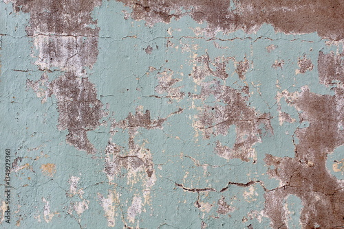 Foto Texture of cracked painted plaster on a wall.