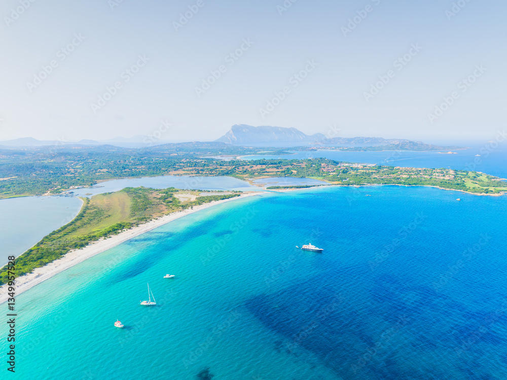 Drone view of the sea coast. Shore and sea water. Vacation and travel. Summer seascape. Transparent sea water and waves. Photography for background, postcards, wallpapers.