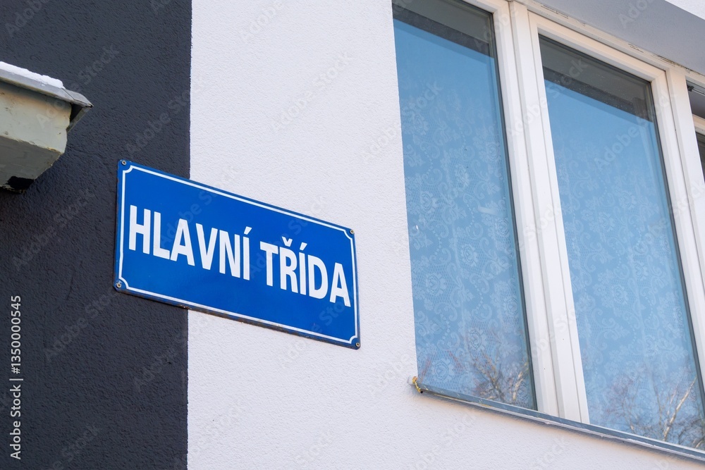 Street sign showing text Hlavni trida in Czech language translated as Main street