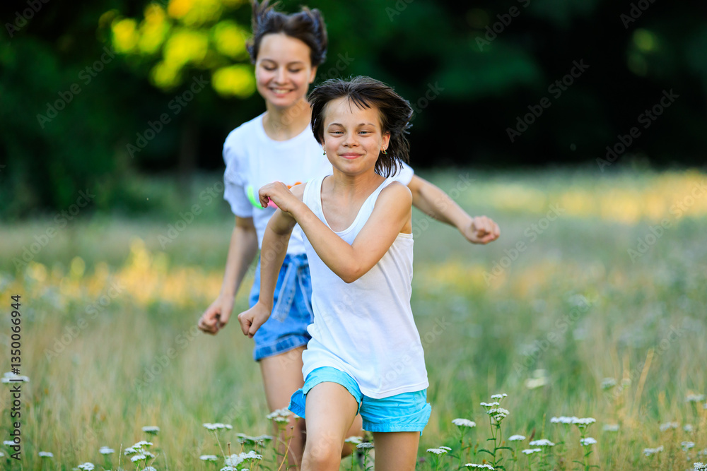 Portrait of sisters spending time together in park in summer