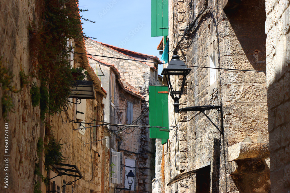 Picturesque Mediterranean street and traditional architectural details in Trogir, Croatia.