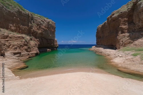 Coastal cove with turquoise water.  Sandy beach framed by rocky cliffs