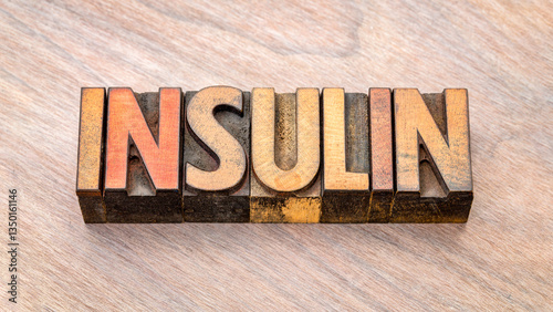 insulin word in vintage letterpress wood type against grained wood, medical concept
