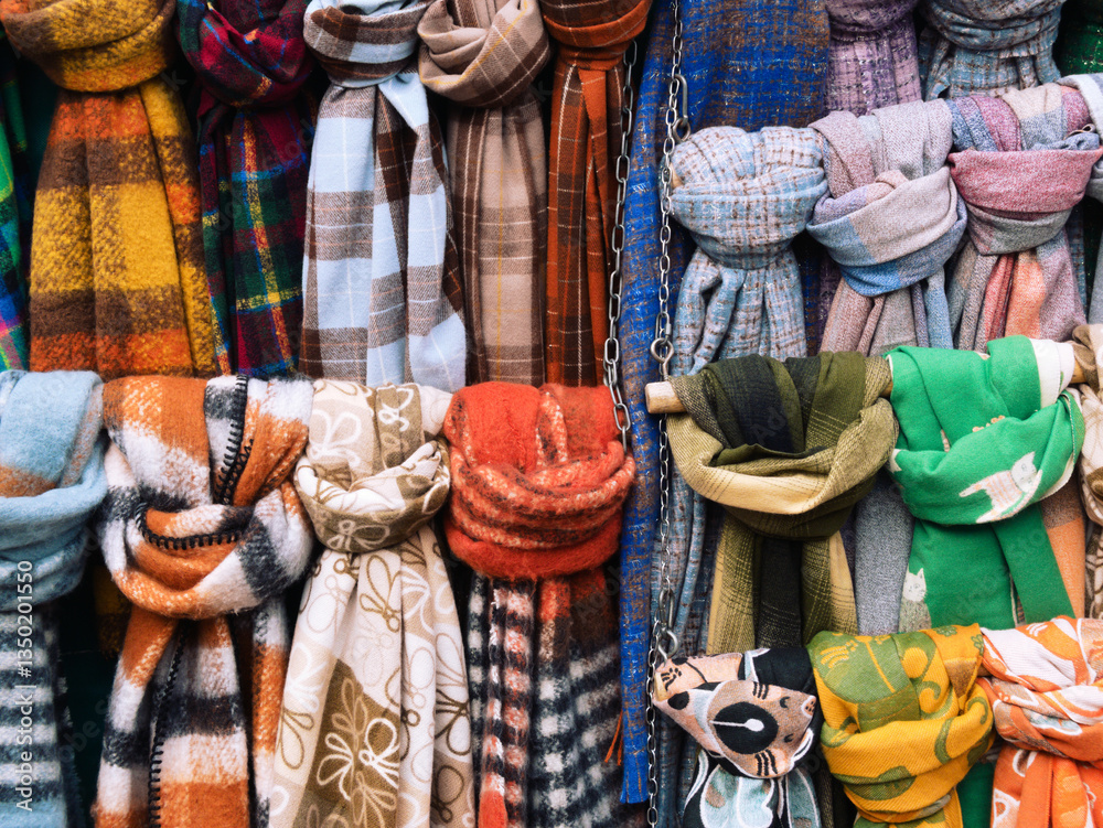 Fototapeta premium Multicoloured scarfs on a rack at a market stall